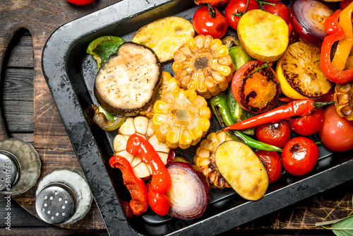 Different grilled vegetables with herbs and spices.