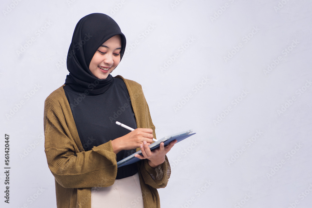 Happy Young Hijab Woman Holding Pen and Clipboard Isolated Happy Young Hijab Woman Holding Pen and Clipboard Isolated