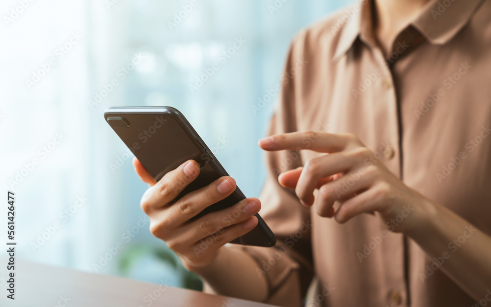 Hand holding smartphone with using social media on internet.