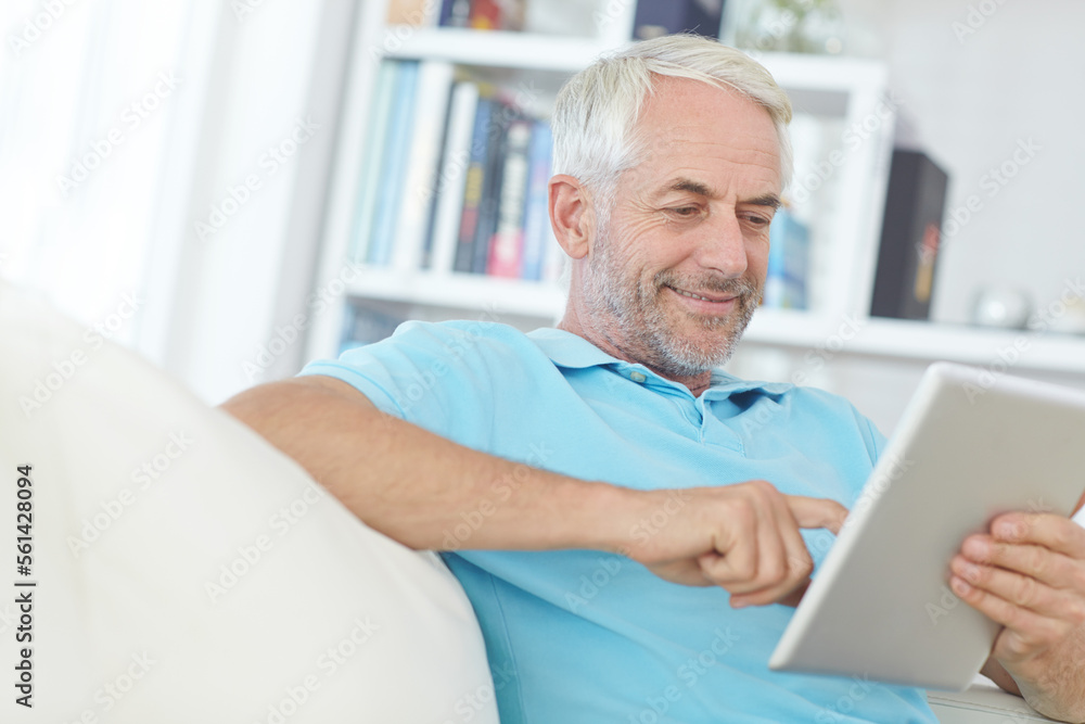 Mature man, digital tablet or relax on sofa in house, home or apartment living room on social media app or internet game. Smile, happy or retirement person on technology crossword puzzle or streaming Mature man, digital tablet or relax on sofa in house, home or apartment living room on social media app or internet game. Smile, happy or retirement person on technology crossword puzzle or streaming