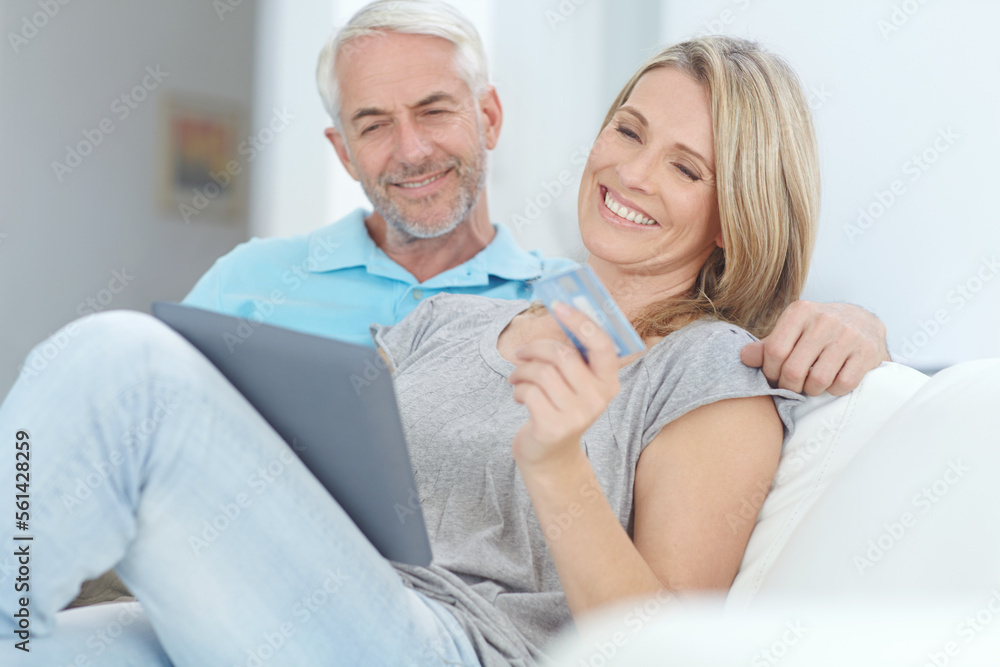Mature couple, credit card or tablet banking for financial management, investment security or finance in living room. Smile, happy or relax man or woman on technology for house insurance or home loan Mature couple, credit card or tablet banking for financial management, investment security or finance in living room. Smile, happy or relax man or woman on technology for house insurance or home loan