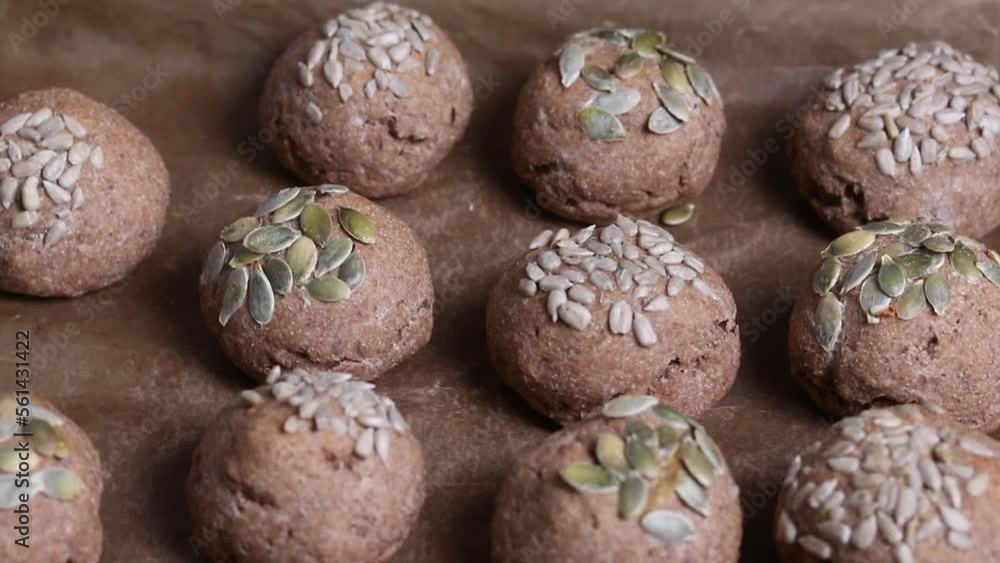 Baked whole grain buns. They lie opposite. Close-up. Baked whole grain buns. They lie opposite. Close-up.