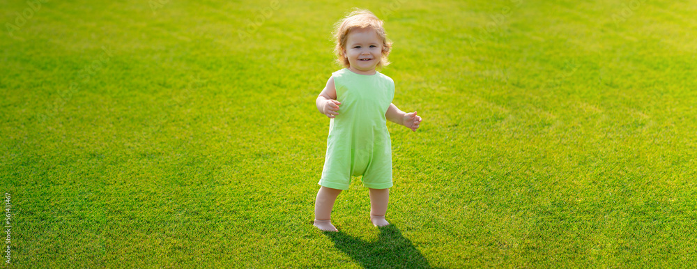 Baby on spring grass field, banner. Little baby learning to crawl steps on the grass. Concept childrens months. Happy child playing on green grass playground. First step. Baby on spring grass field, banner. Little baby learning to crawl steps on the grass. Concept childrens months. Happy child playing on green grass playground. First step.