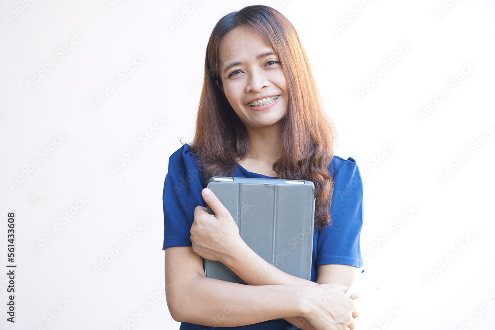 Asian woman holding a portable computer in hand. Asian woman holding a portable computer in hand.
