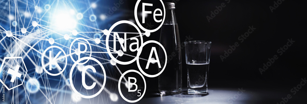 Obraz premium Close up pouring purified fresh drink water from the bottle on table in living room. Drinking water. Mineral vitamin water. Healthy, mineral-rich, refreshing water.