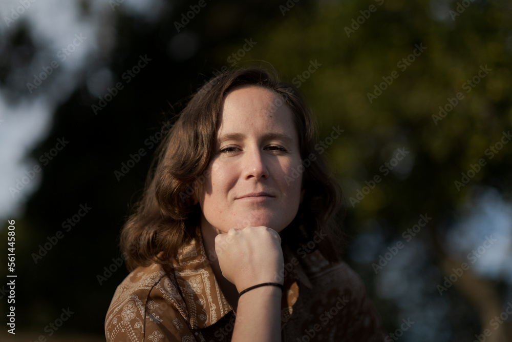A nonbinary White person expresses themselves outdoors in a femme-presenting manner. A nonbinary White person expresses themselves outdoors in a femme-presenting manner.