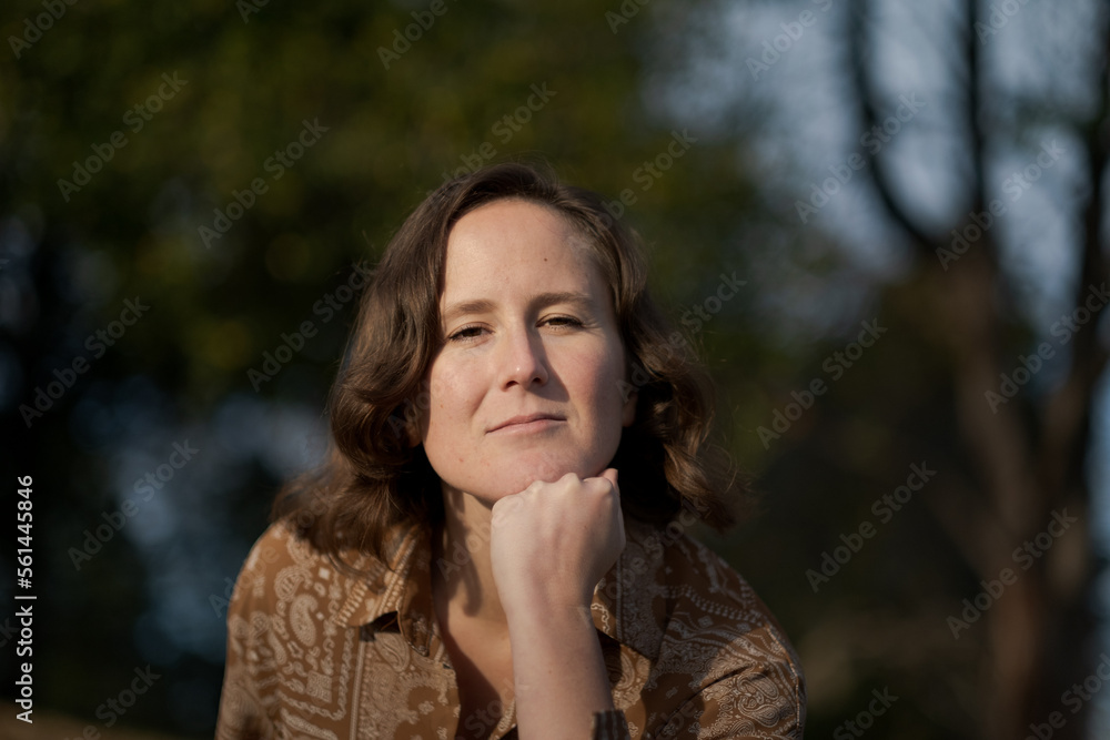 A nonbinary White person expresses themselves outdoors in a femme-presenting manner. A nonbinary White person expresses themselves outdoors in a femme-presenting manner.