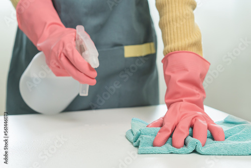 Cleanliness, asian young woman working chore clean up on white table, hand wearing gloves using rag rub remove dust with spray bottle. Household hygiene clean up, cleaner, equipment tool for cleaning.