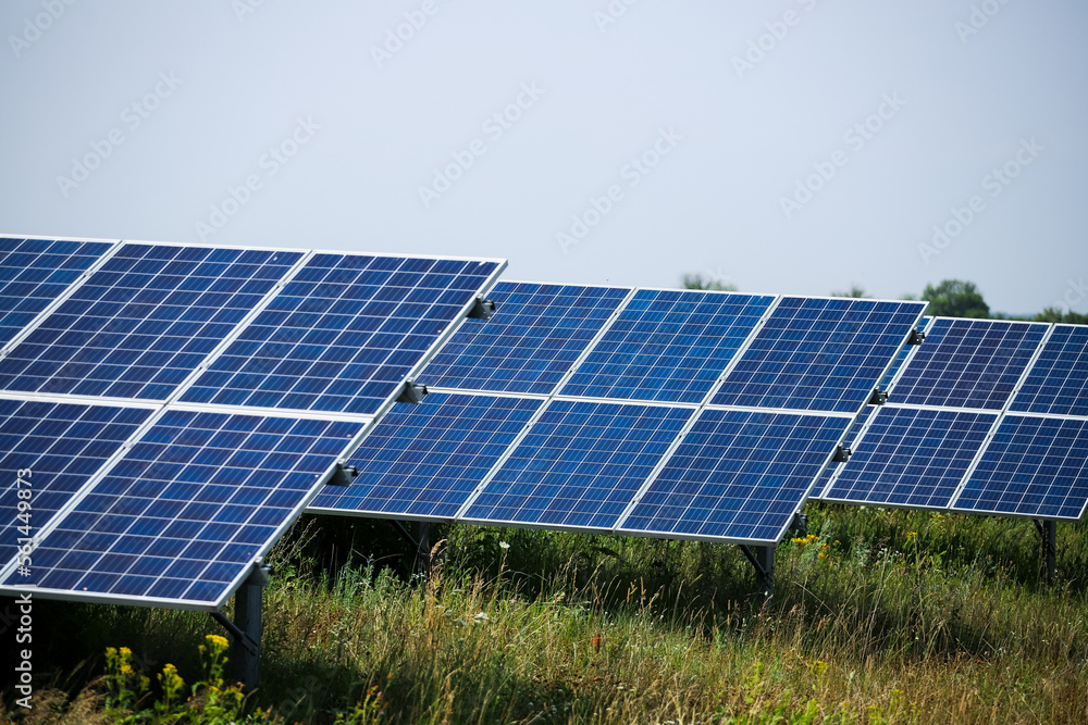 Energy Solar Panel fields on a green hills.