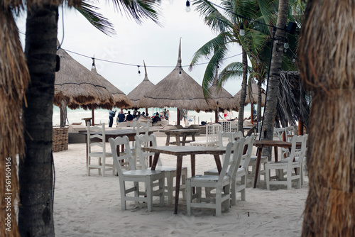 Tropical beach setting on Isla Holbox  Quintana Roo  Mexico. Restaurant with WHITE wooden furniture