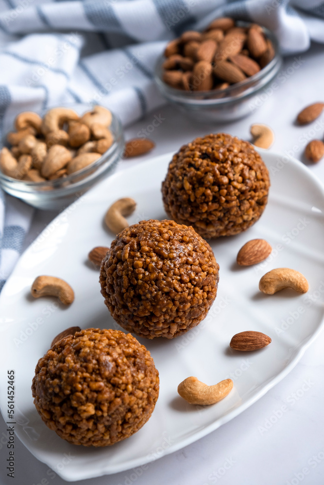 Cookie balls made of biscuit crumbs, cashew and almons nuts and caramel on white plate. Easy recipe of homemade dessert without baking. Bliss balls for tea time. Cookie balls made of biscuit crumbs, cashew and almons nuts and caramel on white plate. Easy recipe of homemade dessert without baking. Bliss balls for tea time.