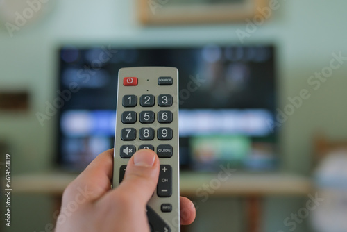 Man hand while browse smart tv app,zapping channels on leisure time,tech lifestyle