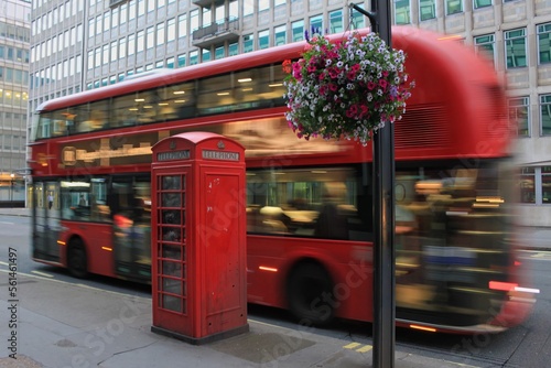 Double Decker Bus in motion on London streets with Telephone Booth