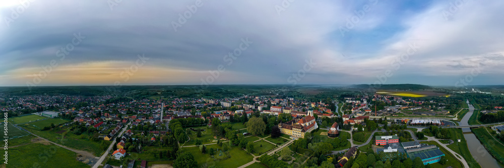 180 degerees panoramic cityscape about Szentgotthard town in west Hungary. The Cistercian abbey' church and garden in visible in the middle.