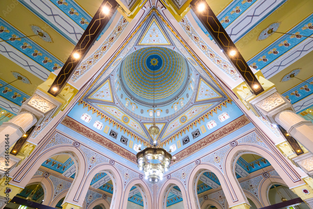 Symmetrical wide angle view of the colorful interior of the Jumeirah mosque in Dubai
