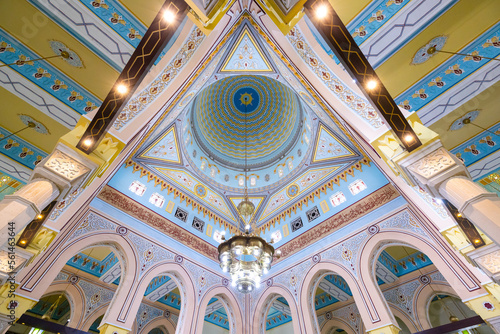 Symmetrical wide angle view of the colorful interior of the Jumeirah mosque in Dubai photo