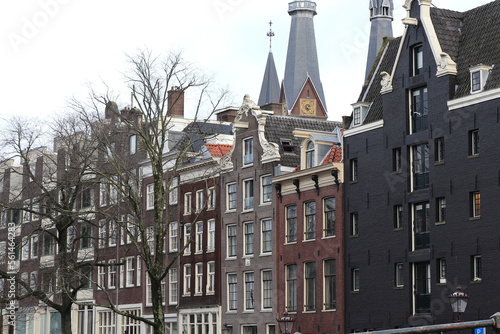 Amsterdam Korte Prinsengracht Canal Traditional House Facades View with Church Towers and Bare Trees  Netherlands