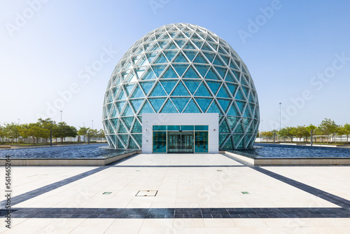 Symmetrical view of the modern-looking light blue spherical visitor center of the Sheik Zayed mosque at Abu Dhabi