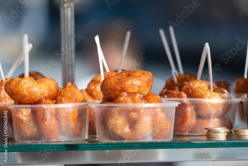 Photography Lokma, traditional deep fried Turkish dessert, street food for sale all over Turkey but the sweet made of syrup and dough is famous in Izmir