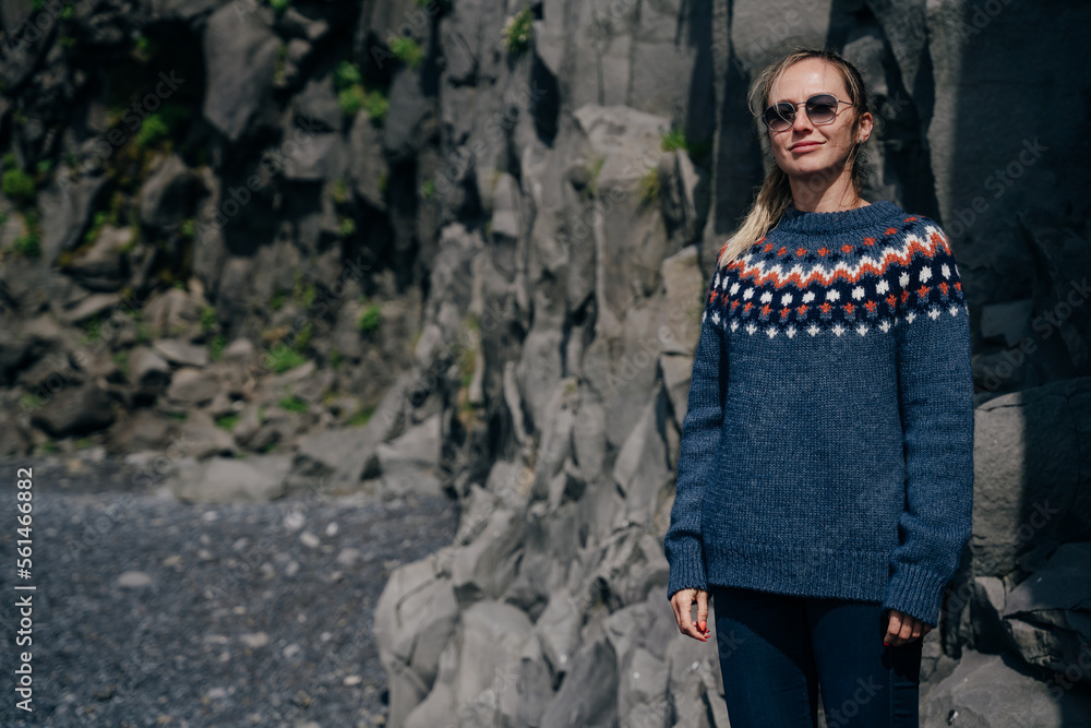 girl in a sweater on the background of the mountains in iceland girl in a sweater on the background of the mountains in iceland
