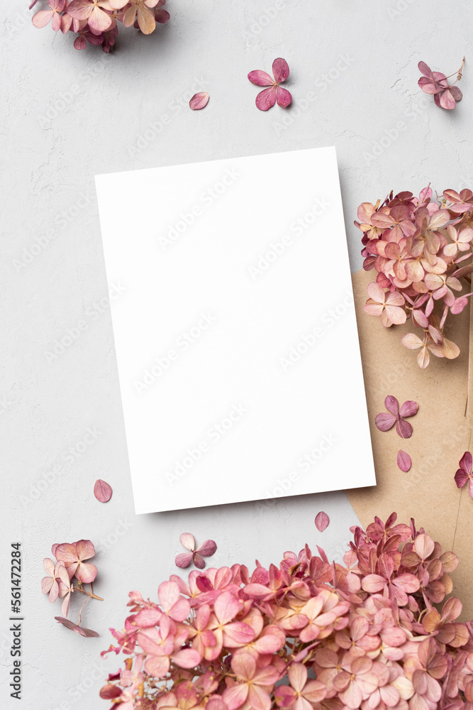 Blank invitation or greeting card mockup with flowers, wedding card flat lay