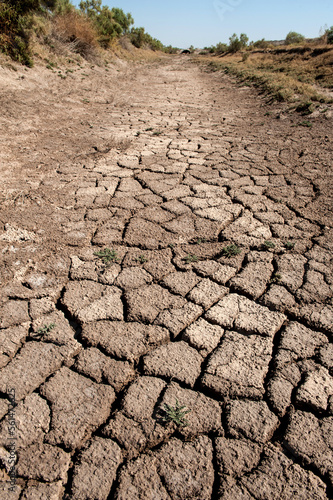 Cracked earth of dry river bed at Charax archaeological site near Basra in Iraq, weather and climate change causing desertification in the Middle East