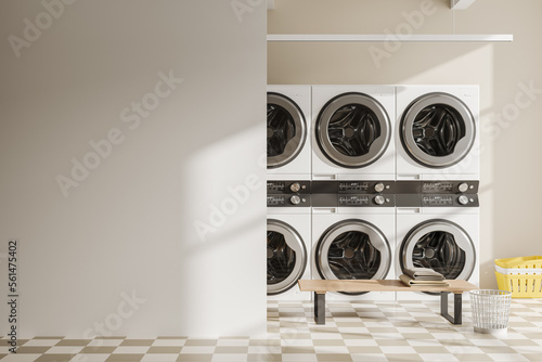 Fotografija Light laundry interior with washing machines in row and bench