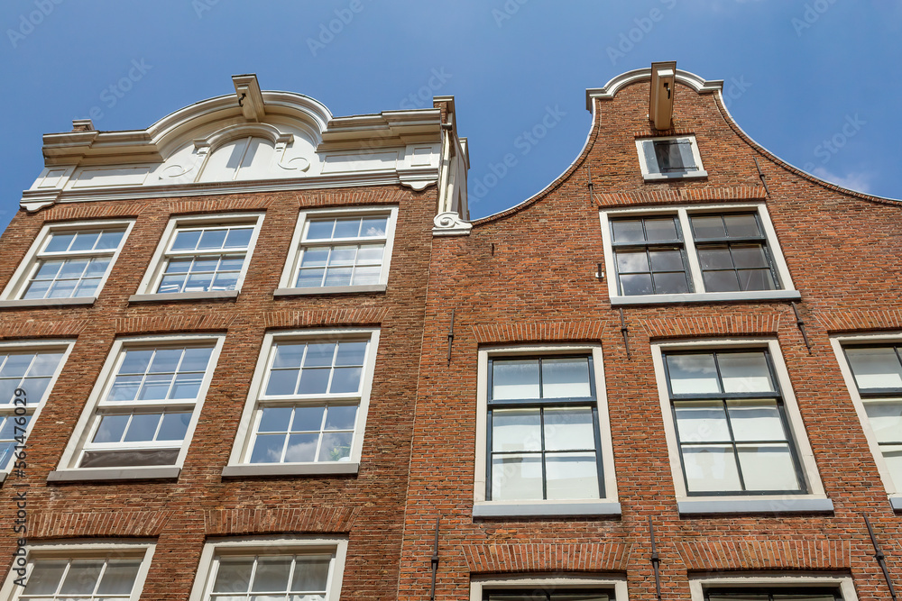 Two Amsterdam houses with blue sky in the background.
Netherlands.