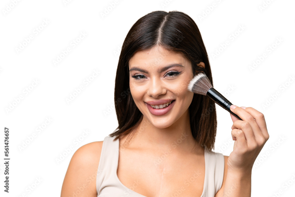 Young Russian woman with rainproof coat and umbrella over isolated chroma key background holding makeup brush Young Russian woman with rainproof coat and umbrella over isolated chroma key background holding makeup brush