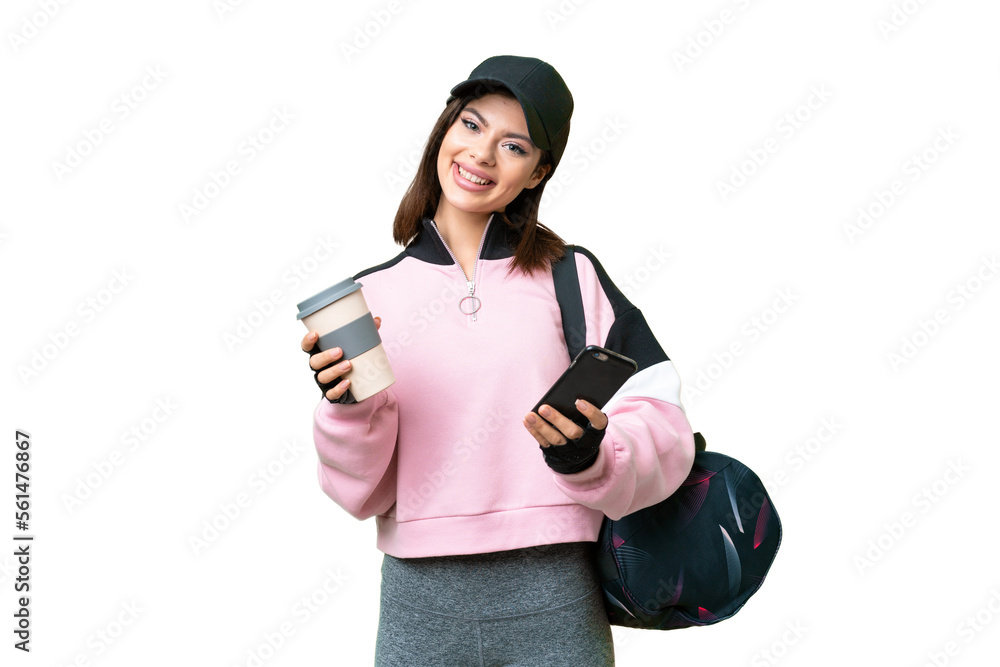 Young sport woman with sport bag over isolated chroma key background holding coffee to take away and a mobile Young sport woman with sport bag over isolated chroma key background holding coffee to take away and a mobile