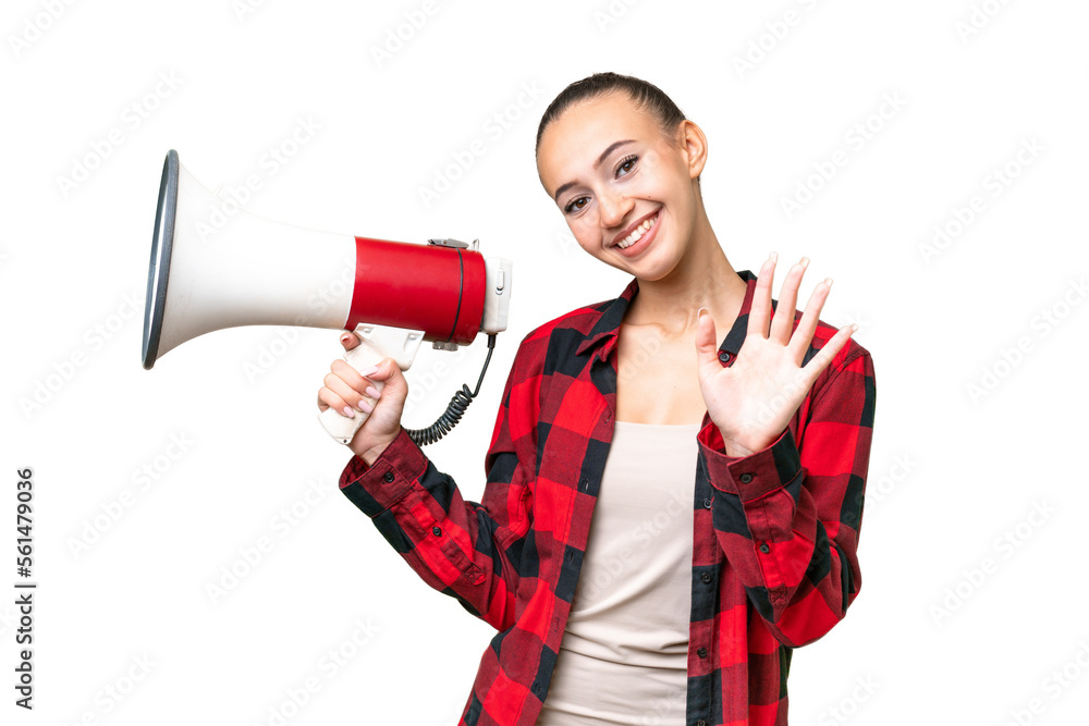 Young Arab woman over isolated background holding a megaphone and saluting with hand with happy expression Young Arab woman over isolated background holding a megaphone and saluting with hand with happy expression
