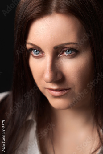 Portrait of Caucasian ethnicity adult woman forty years old. Beautiful female human face of brunette with gray eyes. Soft selective focus, deep-of-field of eyes.
