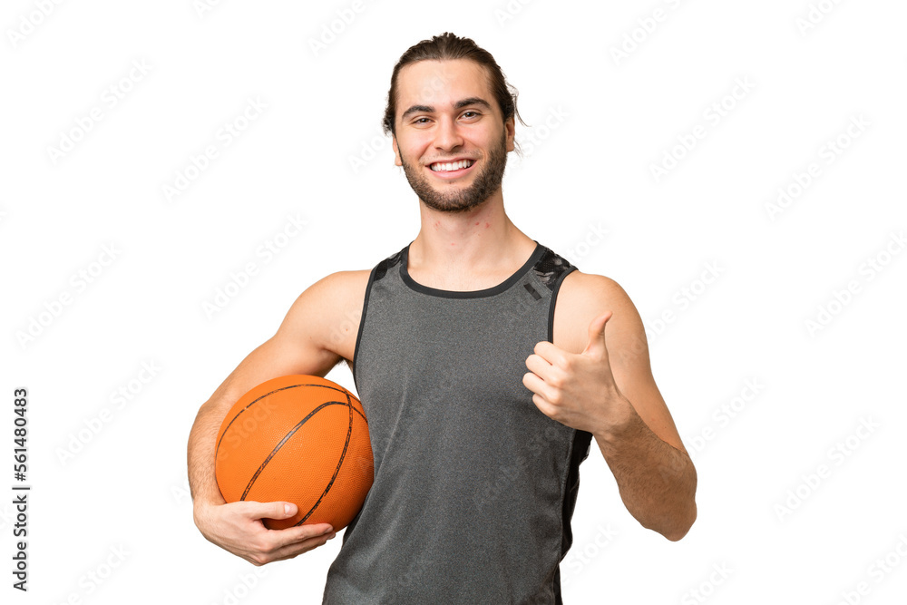 Obraz premium Young handsome man isolated on green chroma background playing basketball and with thumb up