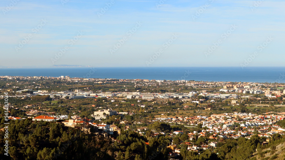 Panoramic view from height of Mediterranean resort seaside town Denia, roofs of the houses, sea in the distance, beautiful landscape