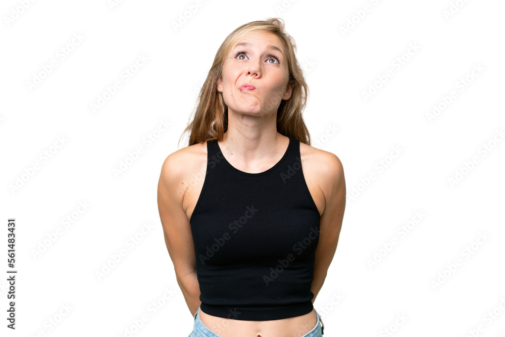 Young blonde woman over isolated background and looking up Young blonde woman over isolated background and looking up