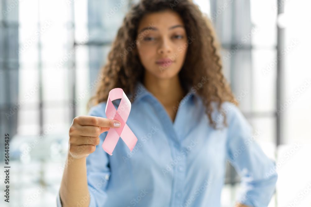 October breast cancer awareness month, woman with hand holding pink ribbon for supporting people living and illness. Healthcare, world cancer day concept.