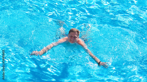 A blond man 40-44 years old pool is engaged in swimming.