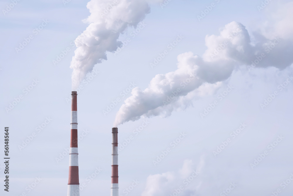Thermal power plant with smoking chimneys against a cloudy sky Thermal power plant with smoking chimneys against a cloudy sky