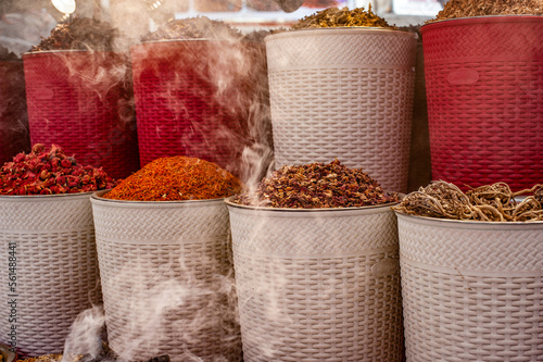 Incense burning alongside colored spices for sale in Dubai Creek Souk  United Arab Emirates  Middle East 
