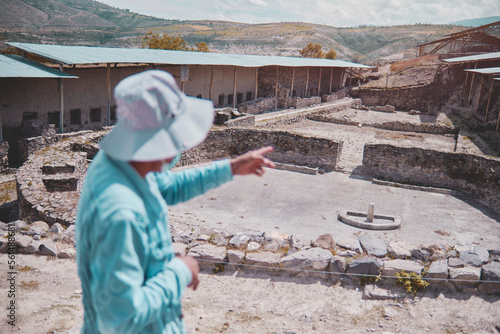 Group of tourists listening the guide explanation about Wari Archaeological Complex, Ayacucho. Peru photo