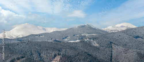 Picturesque winter mountain panorama view from Skupova mountain slope, Ukraine, view to Chornohora ridge and Pip Ivan mountain top with observatory building, Carpathian. photo