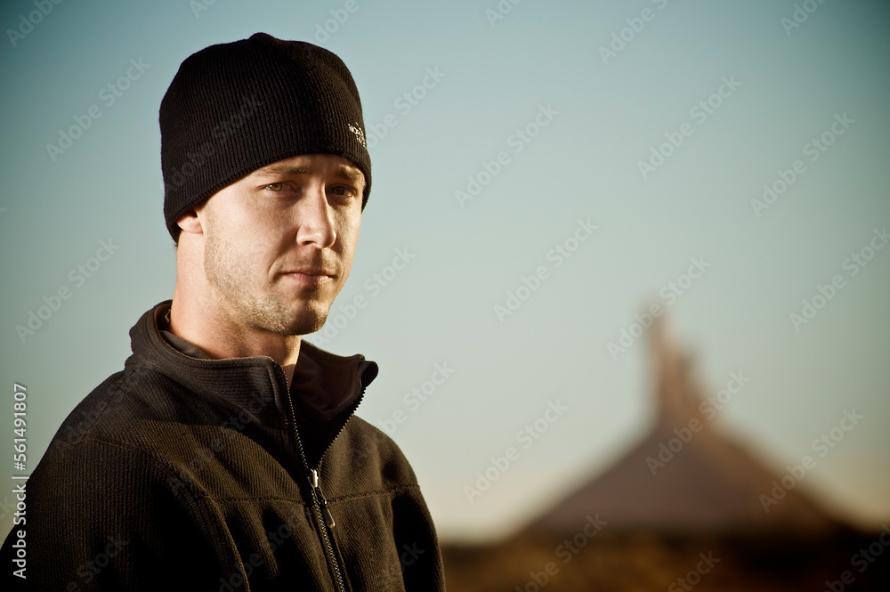 A portrait of a man wearing a fleece and a hat. A portrait of a man wearing a fleece and a hat.