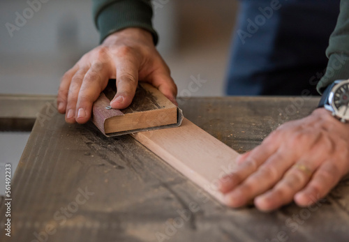 close up of hands working on a wooden board