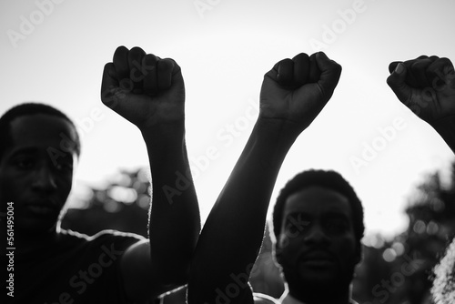 Konstfotografi Black demonstrator people holding hands against racism - Focus on fists - Black
