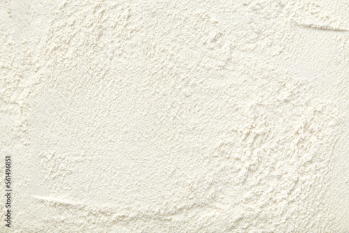 Flour close up background. A pile of flour on a white background. Spilled flour. Flour texture