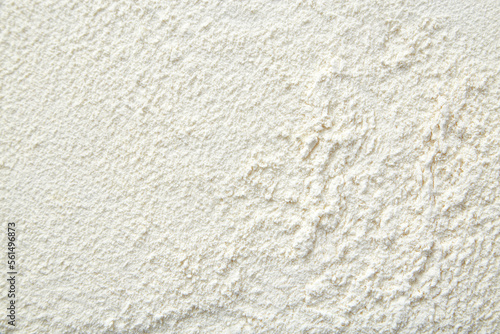 Flour close up background. A pile of flour on a white background. Spilled flour. Flour texture