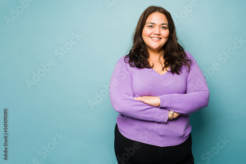 Fat latin young woman looking happy