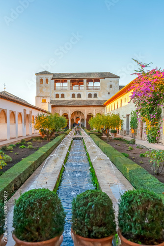 Fountain in green gardens of ancient Alhambra in Granada, Spain on November 26, 2022