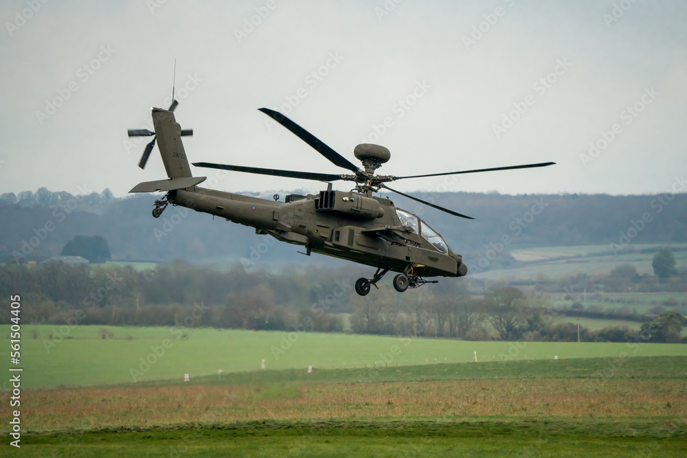 close-up of a British army AH-64E Boeing Apache Attack helicopter (ZM722 ArmyAir606) transitioning to flight on a military exercise, Wilts UK close-up of a British army AH-64E Boeing Apache Attack helicopter (ZM722 ArmyAir606) transitioning to flight on a military exercise, Wilts UK