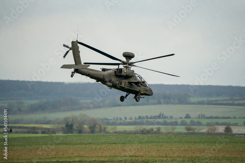 close-up of a British army AH-64E Boeing Apache Attack helicopter (ZM722 ArmyAir606) in low level flight on a military exercise, Wilts UK